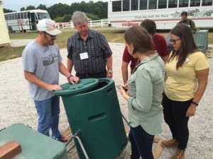 workshop participants look over a compost bin